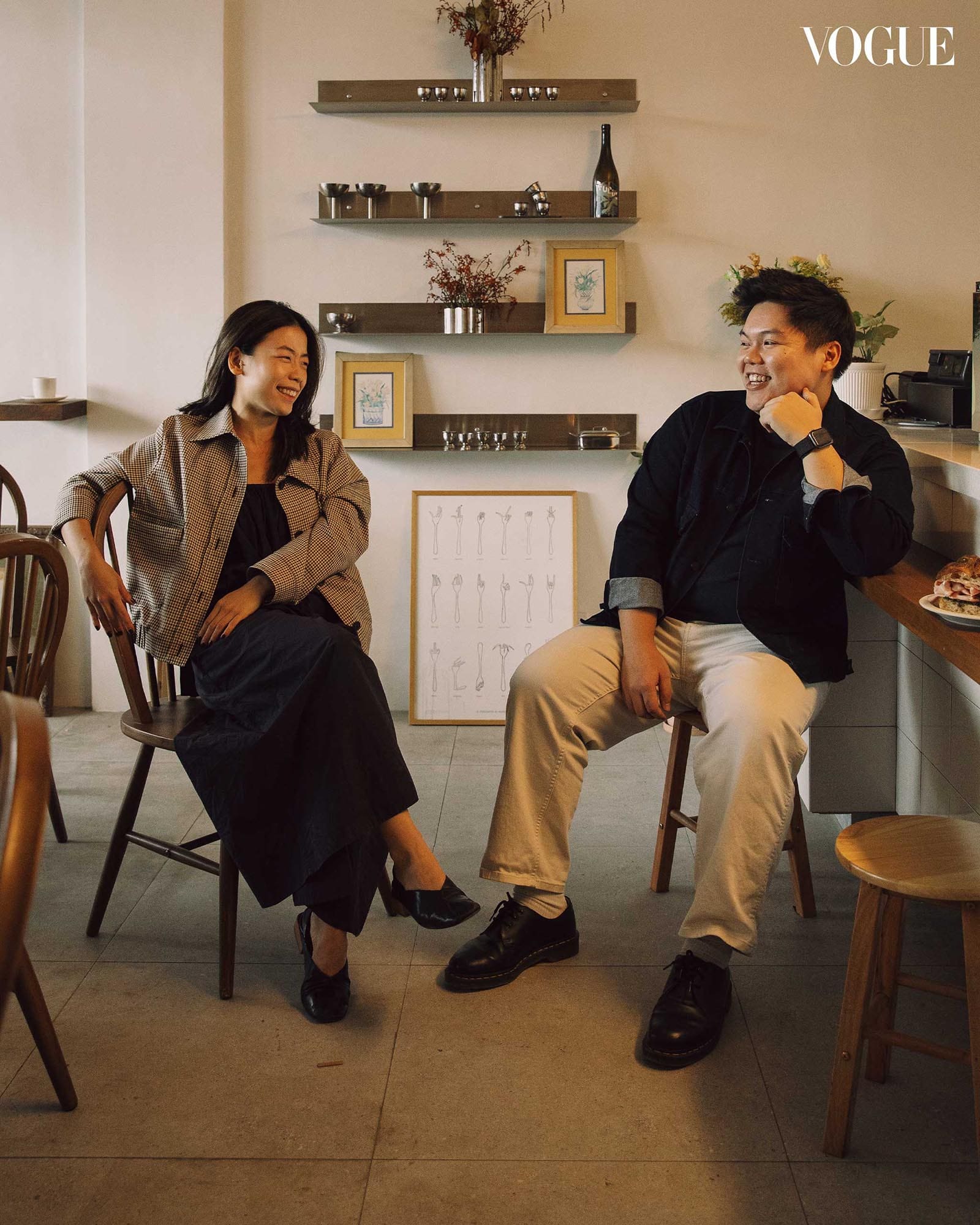 Ani Cafe team members seated inside the cafe with warm lighting and shelves in the background